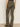 Someone is standing with their back to the camera against a neutral background, wearing Sanctuary Clothing's sculpted brook bootcut pant in kalamata and leopard print flats.