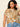 A woman with curly dark hair wears Sanctuary Clothing’s the perfect tee full moon extended sizing—a tan and white patterned short sleeve t-shirt—and light blue jeans. She stands against a plain background, touching her hair, looking neutrally at the camera.