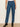 Person wearing blue jeans on a plain background