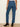 Blue jeans worn by a person on a plain background