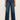 Person wearing blue jeans on a plain background