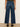 Person wearing blue wide-leg jeans on a plain background