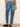 Blue jeans worn by a person on a plain background