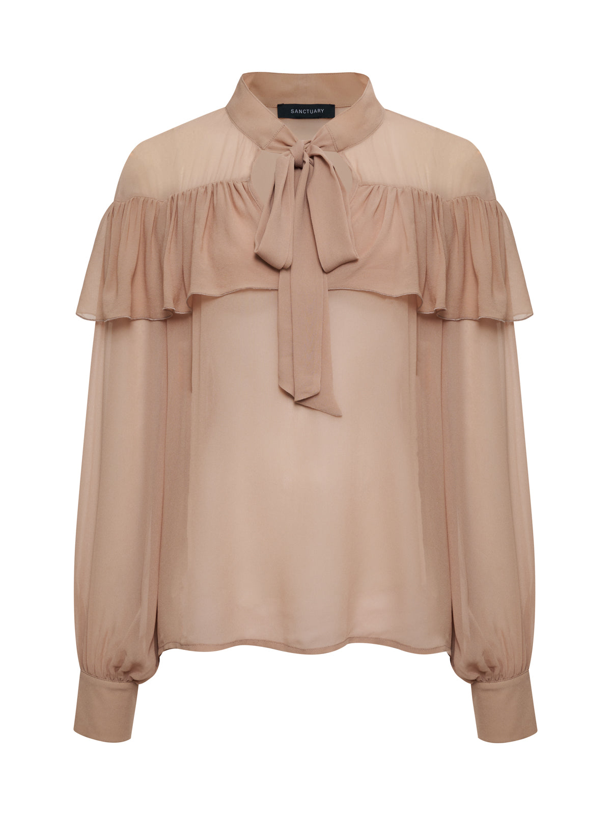 The Sanctuary Clothing "fade into you ruffle blouse fawn" is a sheer, long-sleeved blush pink top featuring a high neck, bow tie collar, ruffled chest and shoulder overlay, and buttoned cuffs.