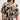A woman wears the Sanctuary Clothing good time tie shirt lotus in petite sizing, featuring short sleeves, a button-down front, and an abstract black, brown, and white print. The dress ties at the waist; she accessorizes with a chunky bracelet.