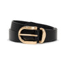 The all day belt black by Sanctuary Clothing, featuring a shiny gold rounded buckle, is coiled loosely against a white background.