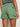 Someone shown from behind, waist down, is wearing Sanctuary Clothing's cadet short green juice—green utility shorts with large back pockets—and a black-and-white striped top.