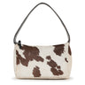 A rectangular shoulder bag with a single strap, covered in white cowhide with irregular brown patches, viewed from the front against a plain white background.