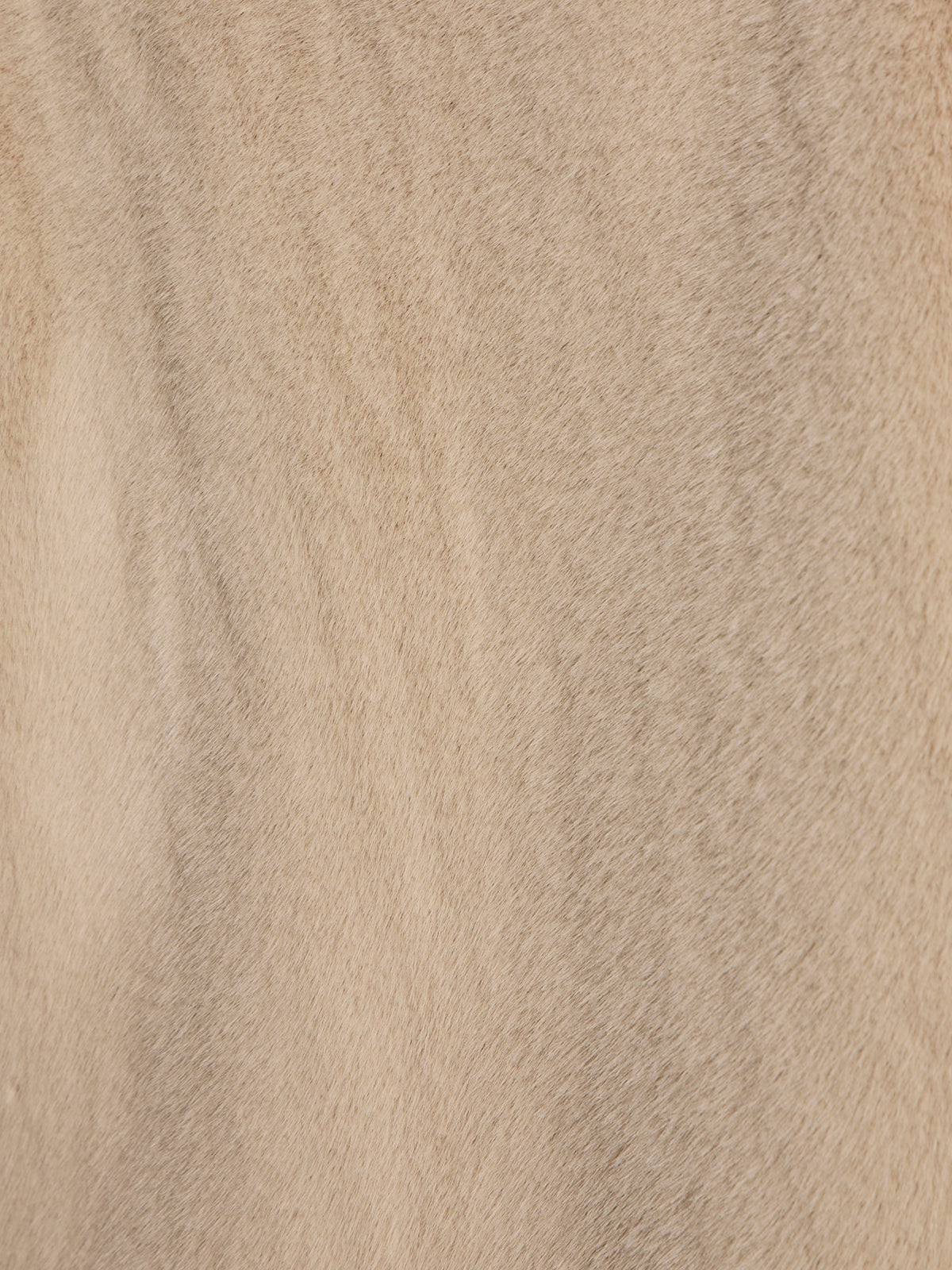 Close-up of soft, uniformly colored almond cream fur with subtle waves and texture, resembling the reversible fur liner jacket by Sanctuary Clothing.