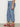 A person stands sideways in Sanctuary Clothing’s the marine jean dollface extended sizing—a light blue, high-waisted, straight-leg style with front patch pockets—paired with red sneakers. Only the lower half is visible against a plain white background.