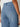 A close-up of the back of a person wearing Sanctuary Clothing's the marine jean dollface in light blue, paired with a white shirt. The focus is on the jeans' high-waisted waistband and rear pockets.