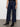 Wearing Sanctuary Clothing's "the marine magnetic" dark blue wide-leg jeans, the person stands on a concrete floor against a plain white wall, with the image highlighting the lower half of their body.