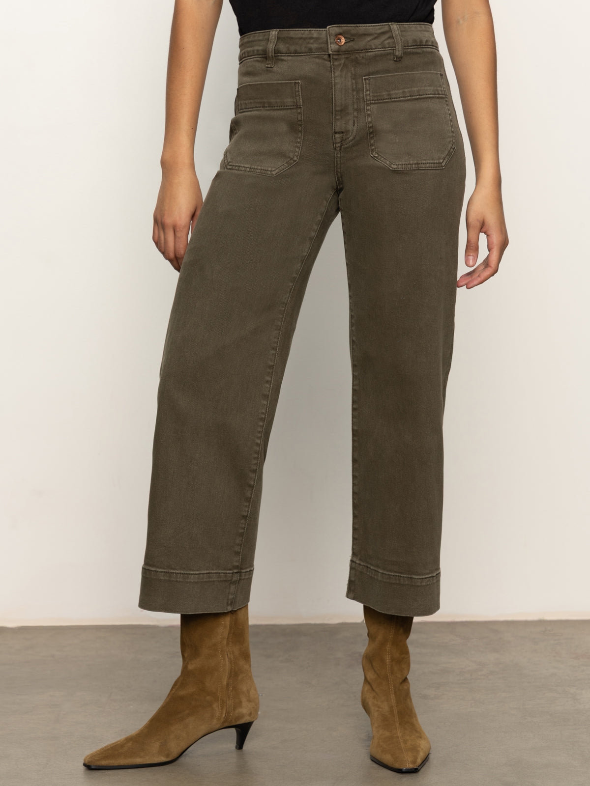 A person wearing the marine crop trouser pant fatigue by Sanctuary Clothing, featuring olive green fabric and front patch pockets, paired with brown suede ankle boots. Only the lower body is visible against a plain background.
