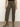 A person wearing the marine crop trouser pant fatigue by Sanctuary Clothing, featuring olive green fabric and front patch pockets, paired with brown suede ankle boots. Only the lower body is visible against a plain background.