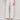 Wearing Sanctuary Clothing's The Marine Crop Jean in Chalk (petite sizing), a person pairs the white, wide-leg, ankle-length jeans with a cream sweater and nude heeled sandals against a light background.