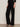 A person models the Sanctuary Clothing marine ponte pant in black with black high-heeled sandals, standing against a plain light background; their upper body and face are not shown.