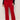 Red pants worn by a person on a plain background