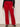 Red pants worn by a person on a plain background