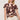 A woman with blonde, wavy, shoulder-length hair models the Sanctuary Clothing "the perfect tee desertscape" t-shirt with beige high-waisted shorts and a brown belt, standing against a plain light background and looking slightly to the side.