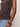 A person wears the Sanctuary Clothing charisma dolman mesh tee rhythmic, styled with light blue jeans and chunky brown and amber bangles, standing against an off-white background.
