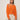 A woman wears the Sanctuary Clothing "for keeps pointelle cardigan" in hibiscus orange with high-waisted beige pants, posing against a plain light-colored wall.
