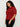 A woman with curly hair stands against a plain light background, wearing the Sanctuary Clothing short sleeve shine sweater tee in cherry lacquer shine (extended sizing), looking down with a neutral expression and her hands by her sides.