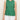 A woman wears the Sanctuary Clothing easy pointelle shell in green juice (petite sizing) with white shorts, standing against a plain light background, arms relaxed by her sides. Her face is partially out of frame.