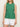 A woman wears the Sanctuary Clothing easy pointelle shell in green juice (petite sizing) with white shorts, standing against a plain light background, arms relaxed by her sides. Her face is partially out of frame.