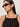 A woman wearing Sanctuary Clothing's for keeps pointelle tank in black and black oval sunglasses looks to the side against a plain background.