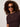 A woman with curly hair wears large dark sunglasses, a gold necklace, and the Sanctuary Clothing perfect knitwear tee in rich soil, standing against a light background.