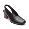 The Sanctuary Clothing Opera Sling Back Pump Black features a round toe, elasticized back strap, and a low, chunky wood-textured heel, shown against a white background.