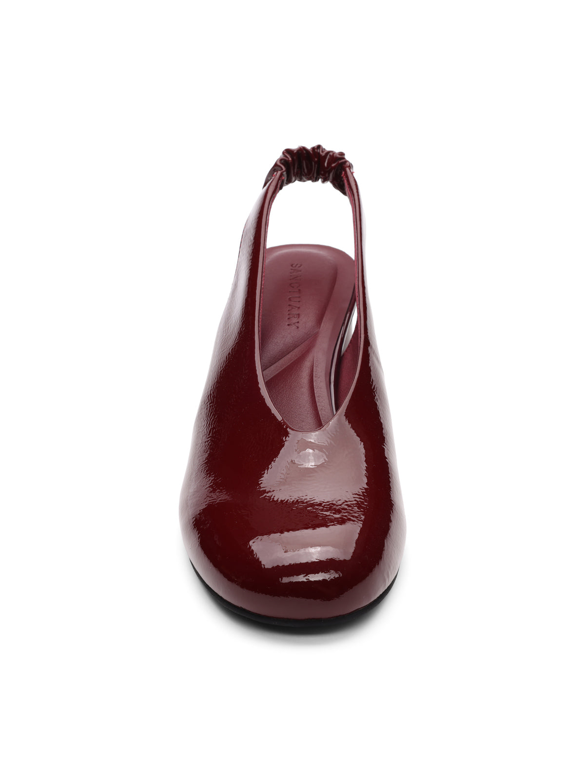 Front view of Sanctuary Clothing¢‚¬„¢s Opera Sling Back Pump in wine, featuring shiny patent leather, a closed toe, elastic back strap, and low-profile sole on a white background.