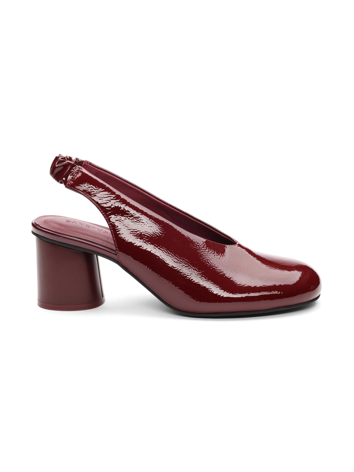 The Sanctuary Clothing Opera Sling Back Pump in wine features shiny dark red patent leather, a low chunky cylindrical heel, and a closed round toe, shown in profile on a white background.
