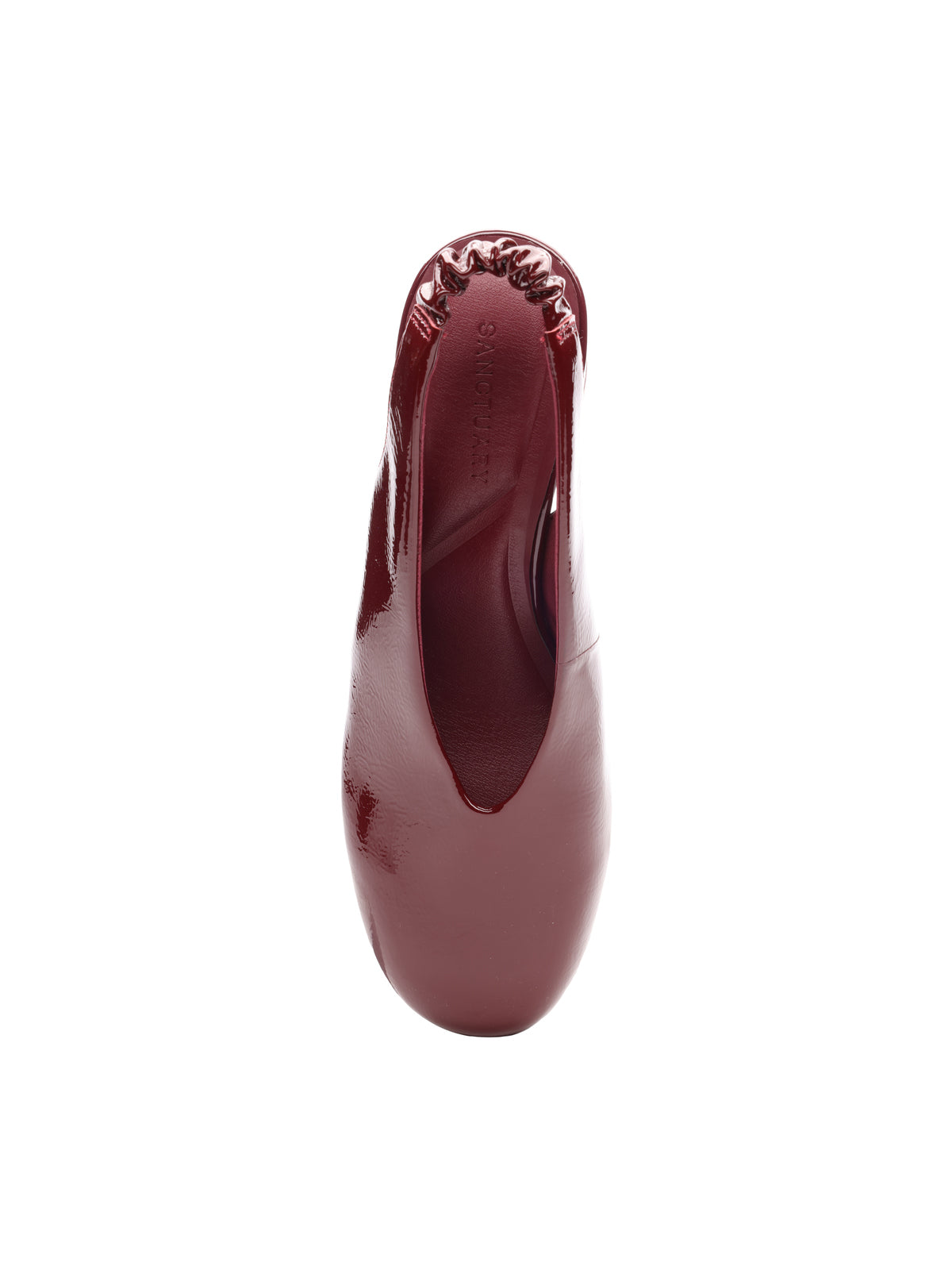 Top view of the Sanctuary Clothing opera sling back pump in wine, featuring burgundy patent leather, a rounded toe, and an elasticized ruched heel. Photographed on a plain white background.