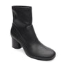 The rory stretch bootie black by Sanctuary Clothing is a black leather ankle boot with a rounded toe and chunky mid-height heel, displayed against a white background.